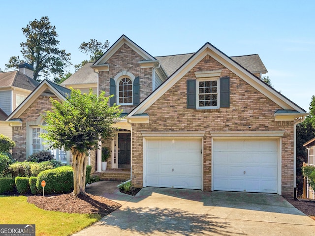 152 Vinings Lake Ct SW, Mableton, GA 30126 - view of front of property featuring an attached garage, brick siding, concrete driveway, and roof with shingles