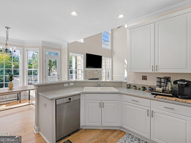 152 Vinings Lake Ct SW, Mableton, GA 30126 - kitchen with light countertops, white cabinets, a peninsula, a sink, and stainless steel dishwasher