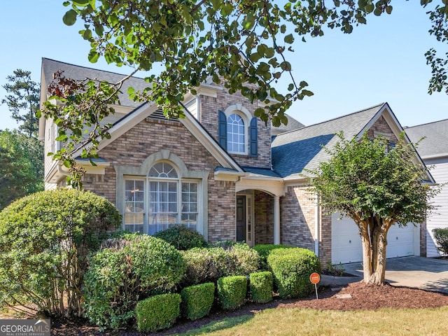 152 Vinings Lake Ct SW, Mableton, GA 30126 - view of front of house featuring driveway, a garage, brick siding, and roof with shingles