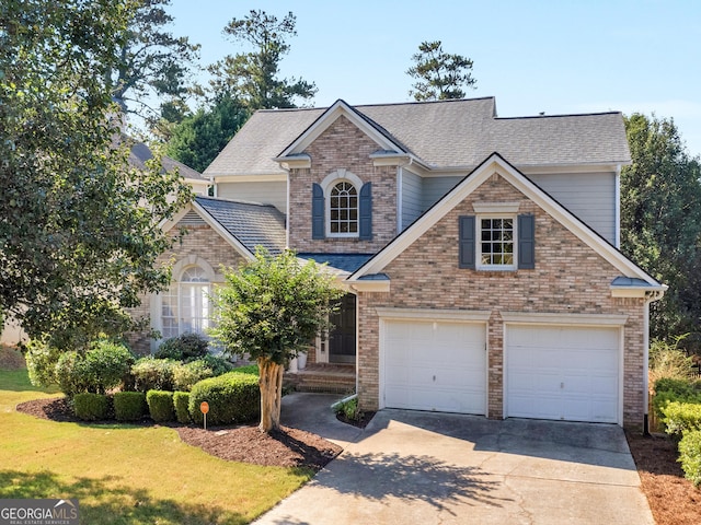 152 Vinings Lake Ct SW, Mableton, GA 30126 - traditional-style home with a garage, concrete driveway, a front yard, brick siding, and a shingled roof