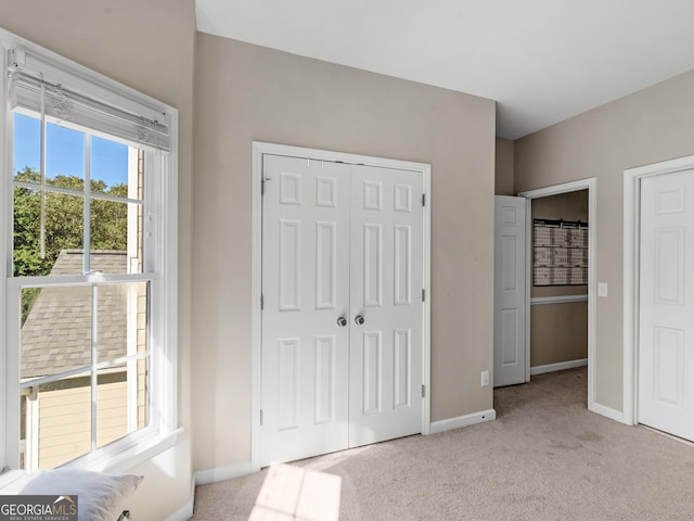 152 Vinings Lake Ct SW, Mableton, GA 30126 - unfurnished bedroom with baseboards, a closet, and light colored carpet