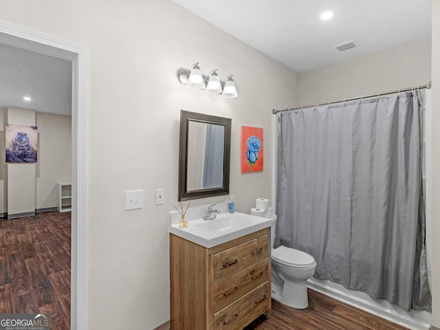152 Vinings Lake Ct SW, Mableton, GA 30126 - bathroom featuring vanity, toilet, visible vents, shower / bath combo with shower curtain, and wood finished floors