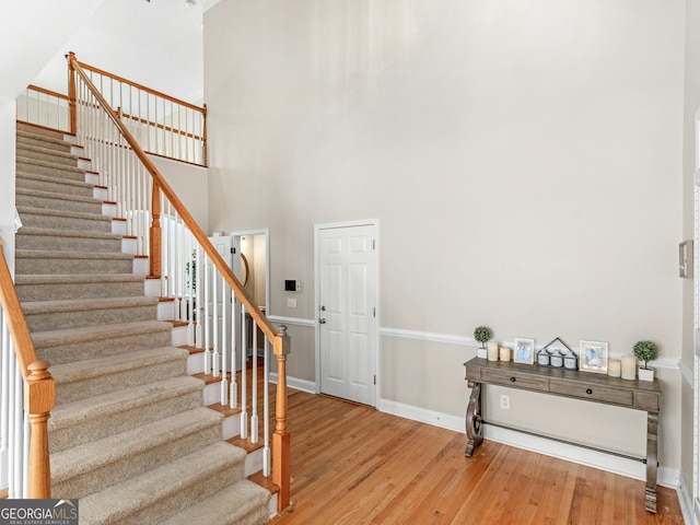 152 Vinings Lake Ct SW, Mableton, GA 30126 - stairway with baseboards, wood finished floors, and a towering ceiling