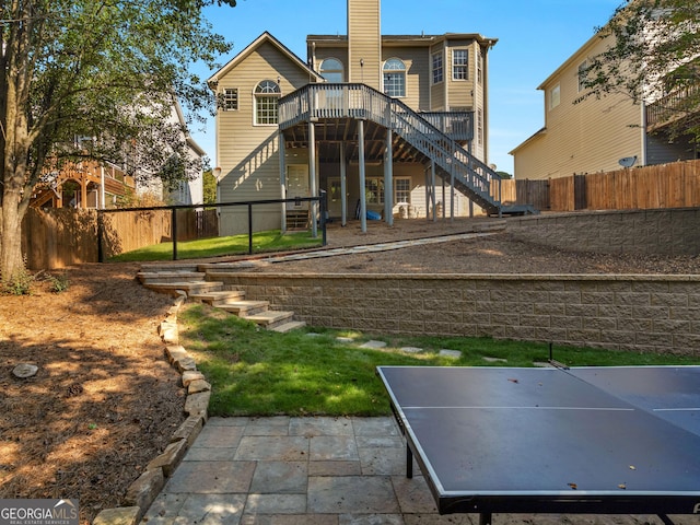 152 Vinings Lake Ct SW, Mableton, GA 30126 - rear view of property featuring a chimney, stairway, a fenced backyard, a deck, and a patio area