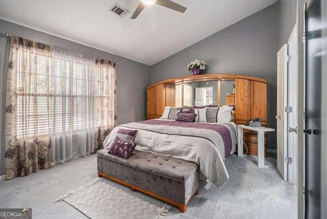 bedroom with visible vents, a ceiling fan, vaulted ceiling, and light carpet