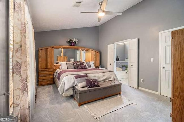 bedroom featuring ceiling fan, visible vents, vaulted ceiling, ensuite bathroom, and carpet