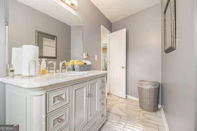 bathroom featuring vanity, marble finish floor, and baseboards