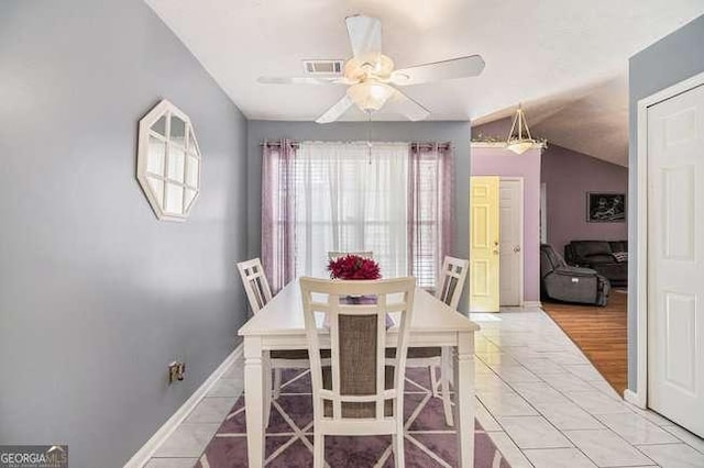 dining room with ceiling fan, visible vents, baseboards, and vaulted ceiling