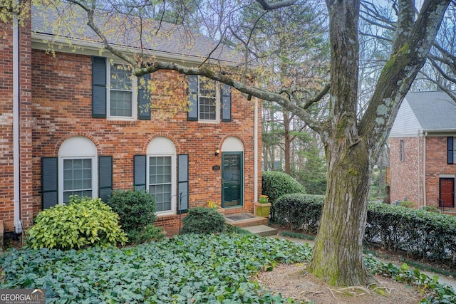colonial-style house featuring brick siding