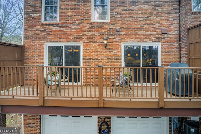 deck featuring grilling area and a garage
