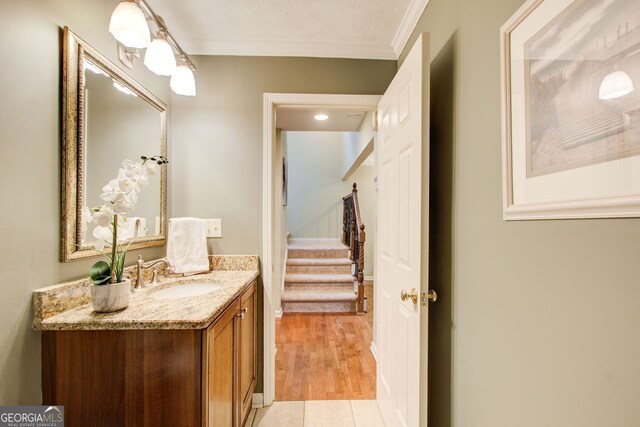 bathroom with vanity and ornamental molding