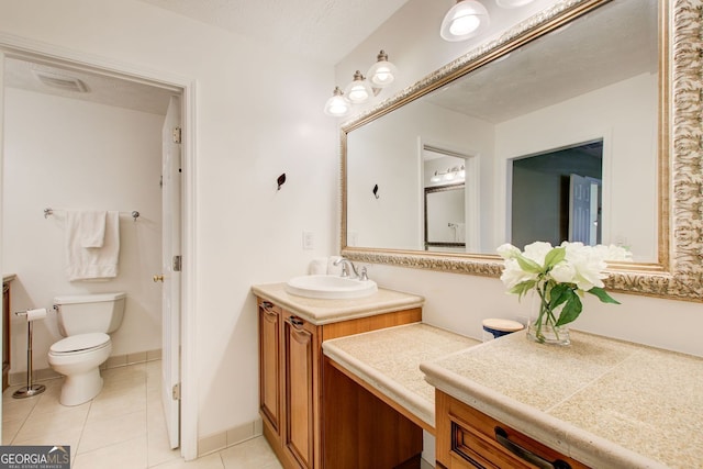 bathroom featuring toilet, vanity, tile patterned floors, and visible vents