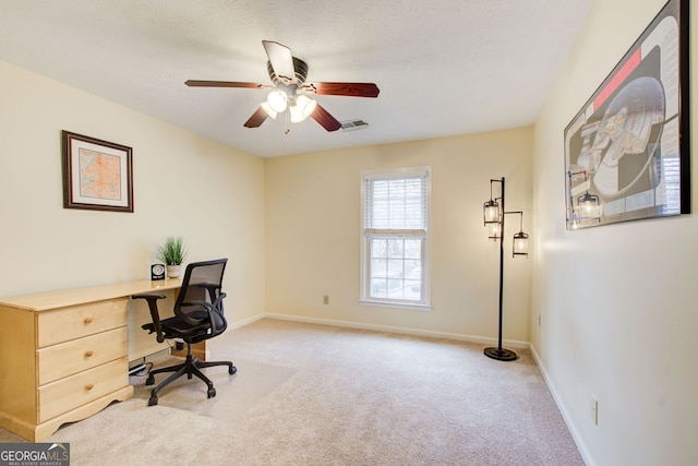 home office featuring baseboards, visible vents, carpet, and ceiling fan