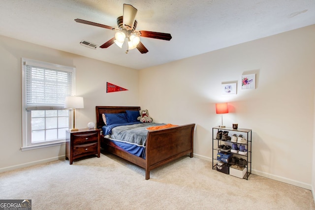 bedroom with visible vents, carpet flooring, baseboards, and a ceiling fan