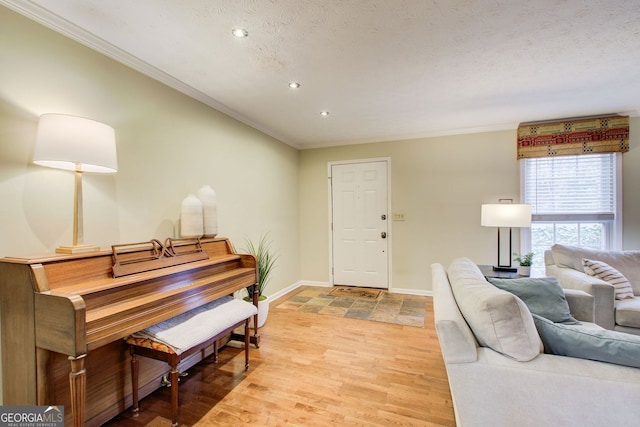 interior space with light wood finished floors, baseboards, recessed lighting, and crown molding