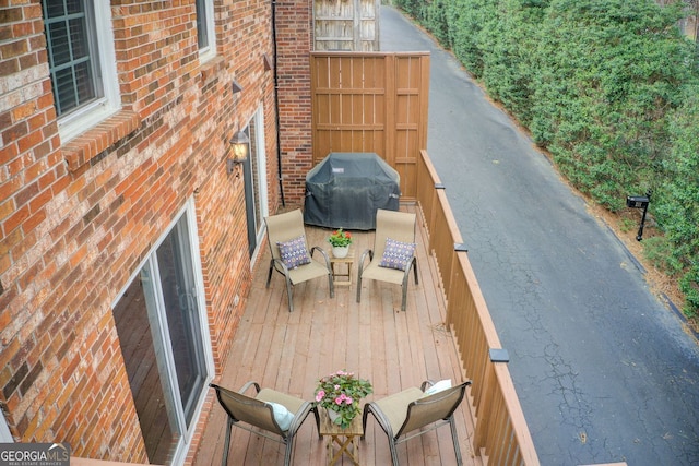 wooden terrace featuring grilling area