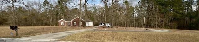 5555 Carlton Ln, Garfield, GA 30425 - view of yard featuring a wooded view and concrete driveway