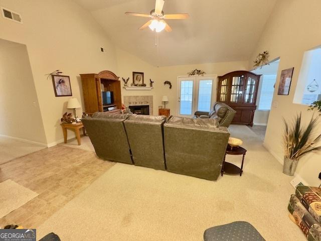 5555 Carlton Ln, Garfield, GA 30425 - carpeted living room featuring a fireplace, ceiling fan, high vaulted ceiling, and baseboards