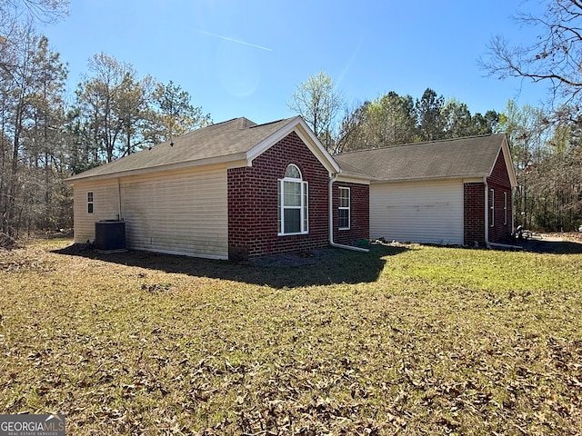 5555 Carlton Ln, Garfield, GA 30425 - view of side of home featuring brick siding, a lawn, and central AC unit