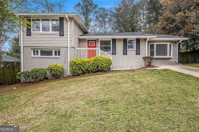 3409 Glensford Dr, Decatur, GA 30032 - split level home with brick siding, a front yard, and fence