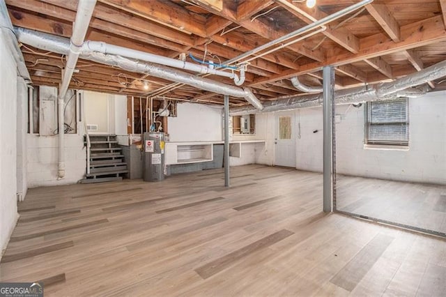 3409 Glensford Dr, Decatur, GA 30032 - basement with stairway, electric water heater, and wood finished floors