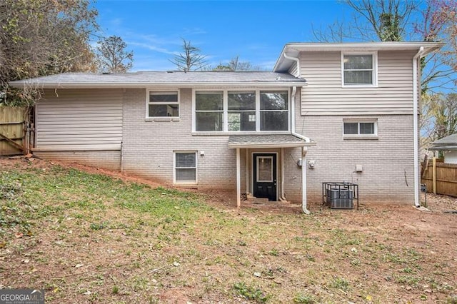 3409 Glensford Dr, Decatur, GA 30032 - rear view of property featuring central AC unit, a yard, fence, and brick siding