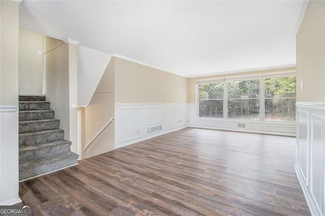 3409 Glensford Dr, Decatur, GA 30032 - unfurnished living room with visible vents, stairs, a wainscoted wall, and wood finished floors