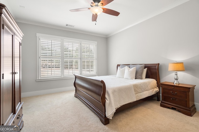bedroom featuring light colored carpet, baseboards, a ceiling fan, and crown molding