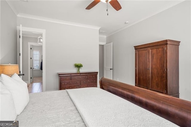 bedroom with crown molding, tile patterned flooring, and a ceiling fan