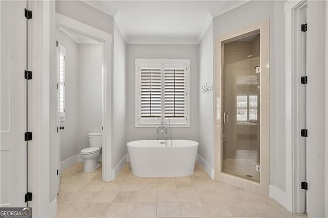 bathroom featuring a stall shower, a soaking tub, toilet, tile patterned flooring, and ornamental molding