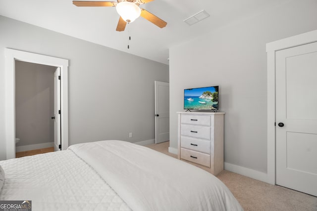 bedroom with baseboards, light carpet, and a ceiling fan
