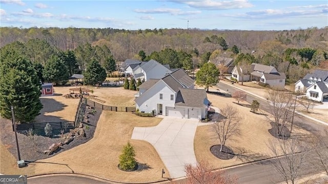 aerial view of residential area featuring a heavily wooded area