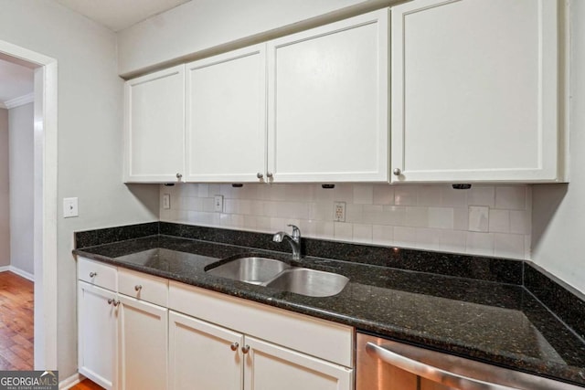 kitchen with dishwasher, white cabinetry, backsplash, and a sink