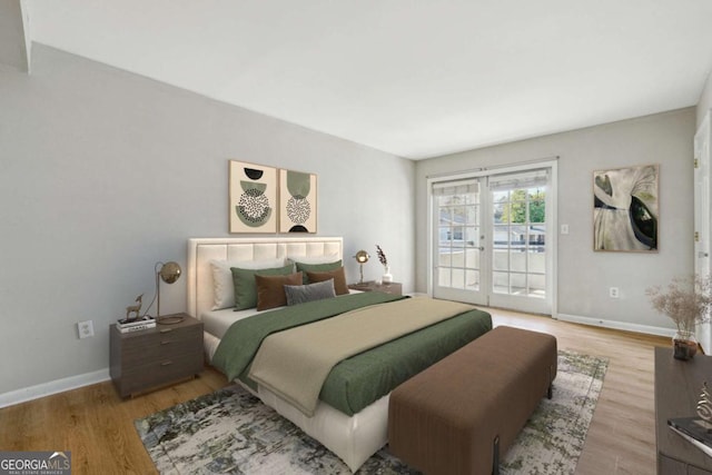 bedroom featuring baseboards, wood finished floors, and access to exterior