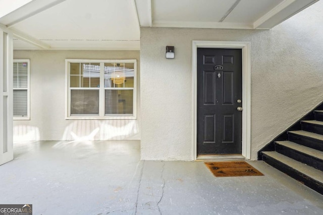 property entrance with stucco siding