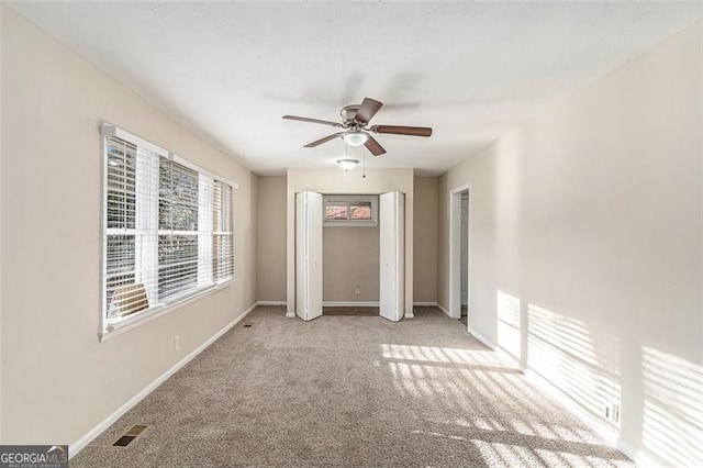 2203 Knoll Dr, Decatur, GA 30032 - unfurnished bedroom featuring visible vents, baseboards, ceiling fan, and carpet flooring