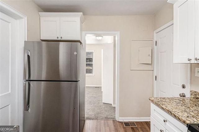 2203 Knoll Dr, Decatur, GA 30032 - kitchen featuring light stone counters, visible vents, white cabinets, and freestanding refrigerator