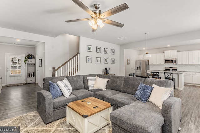 living room with baseboards, stairs, wood finished floors, recessed lighting, and a ceiling fan