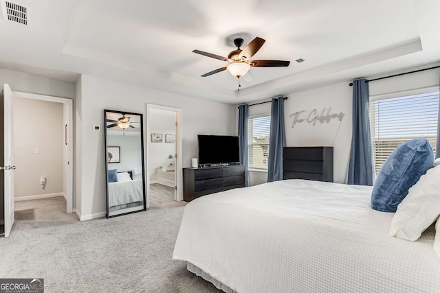 bedroom with carpet floors, a ceiling fan, a raised ceiling, baseboards, and visible vents