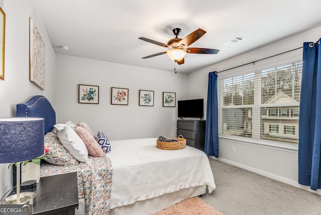 carpeted bedroom with baseboards, visible vents, and ceiling fan