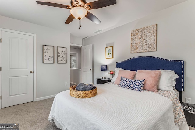 carpeted bedroom featuring baseboards, visible vents, and a ceiling fan