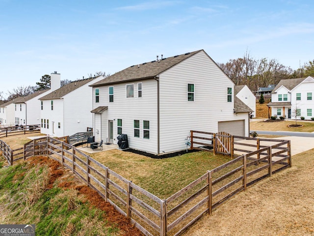 exterior space with a residential view, concrete driveway, a garage, and a front lawn
