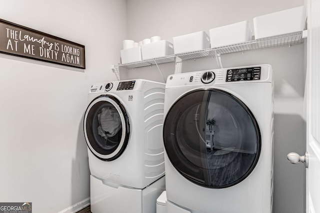 clothes washing area with washing machine and dryer and laundry area