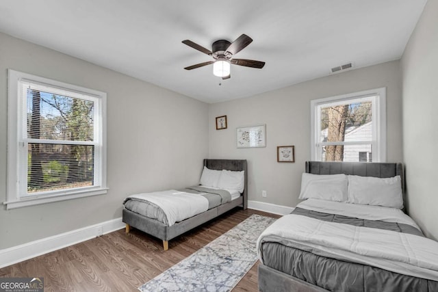 2072 Baker Rd NW, Atlanta, GA 30318 - bedroom featuring visible vents, ceiling fan, baseboards, and wood finished floors