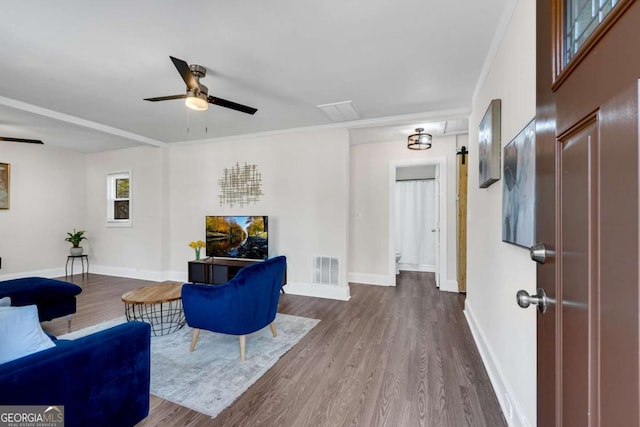 2072 Baker Rd NW, Atlanta, GA 30318 - living area with visible vents, dark wood-type flooring, baseboards, ceiling fan, and ornamental molding