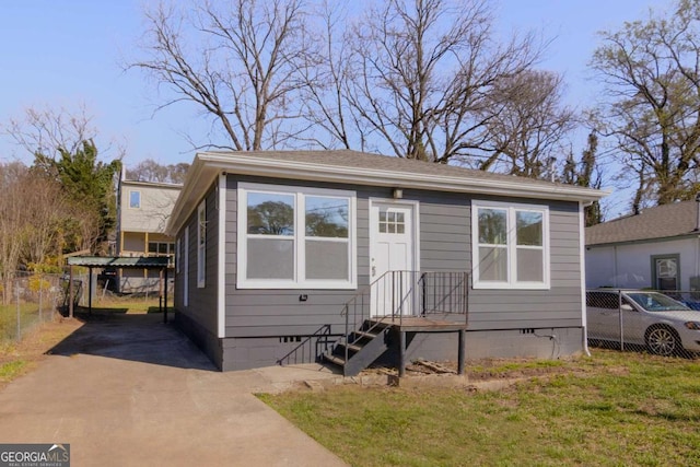 bungalow-style home featuring crawl space, driveway, and fence