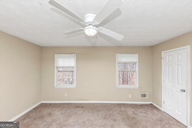 1736 Salem Woods Dr SE, Conyers, GA 30013 - unfurnished bedroom with baseboards, visible vents, ceiling fan, a textured ceiling, and carpet flooring