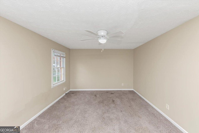 1736 Salem Woods Dr SE, Conyers, GA 30013 - spare room featuring a textured ceiling, baseboards, carpet floors, and ceiling fan