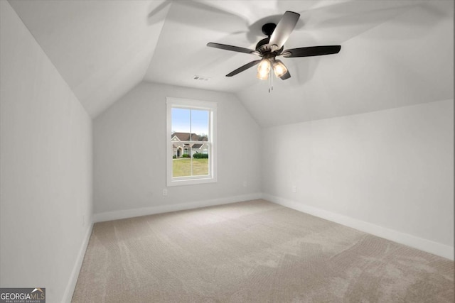 additional living space featuring lofted ceiling, baseboards, and carpet floors