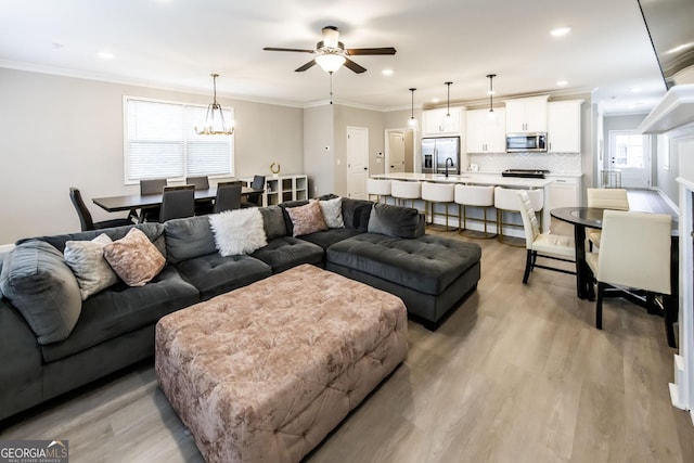 3739 Silvery Way, Powder Springs, GA 30127 - living area with light wood finished floors, recessed lighting, ceiling fan with notable chandelier, and ornamental molding